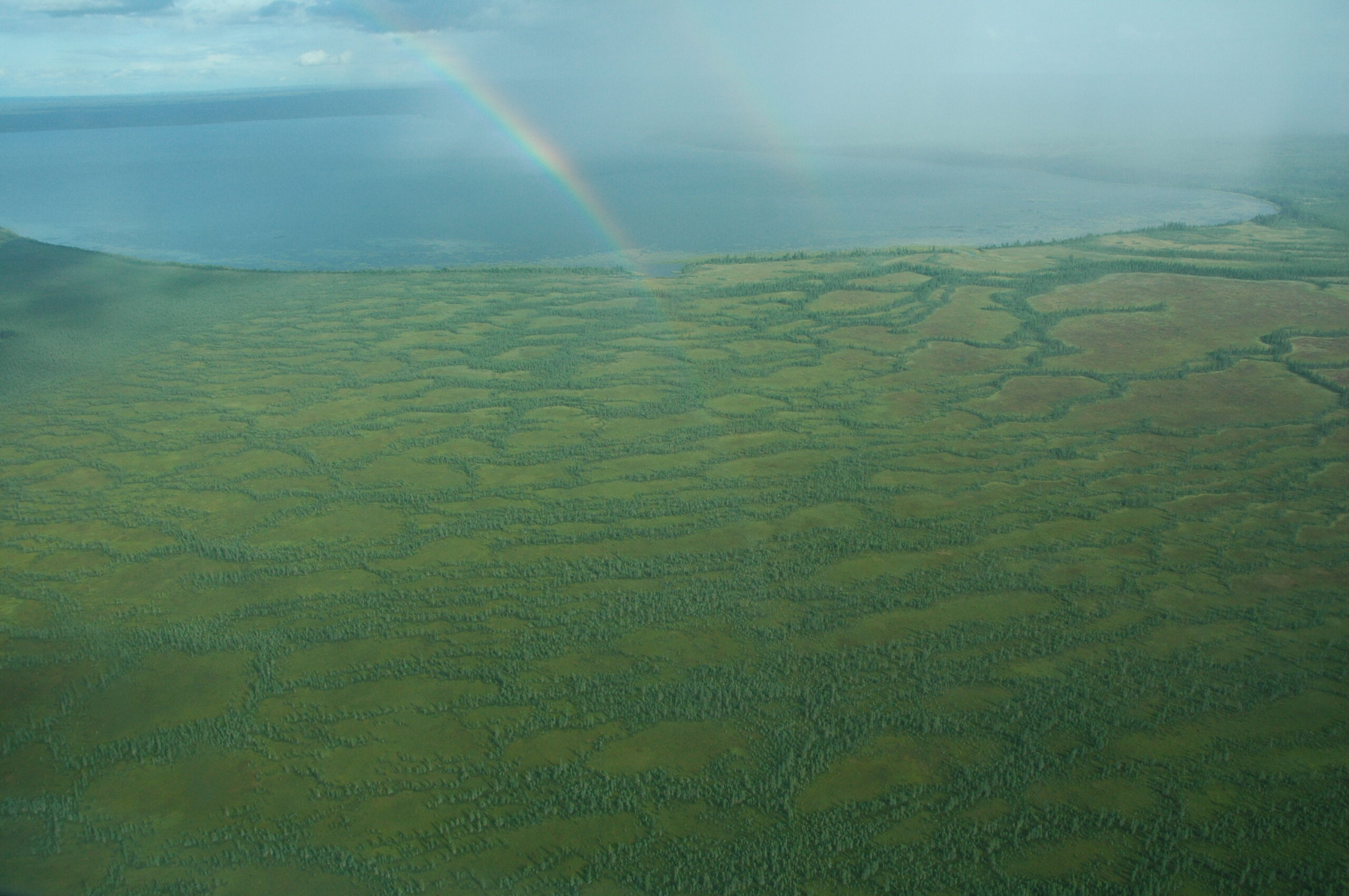 Suncor Fort Hills: a view from above of a wetland complex surrounding McClelland Lake, with a rainbow visible