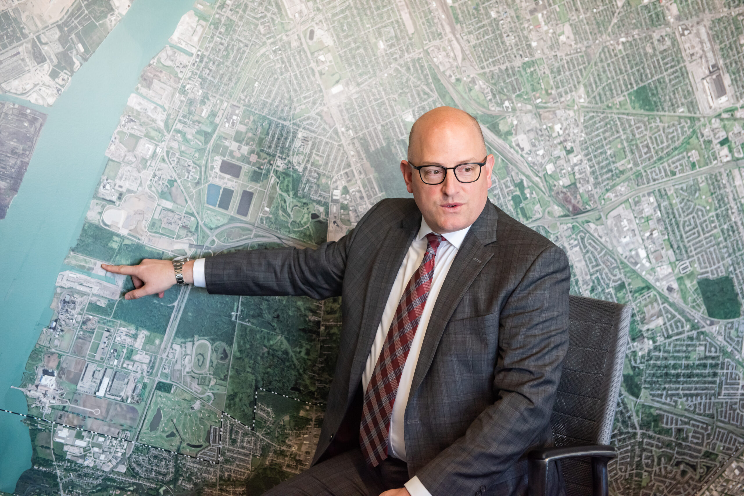 Windsor Mayor Drew Dilkens points at Ojibway Shores on a map of the region in his office