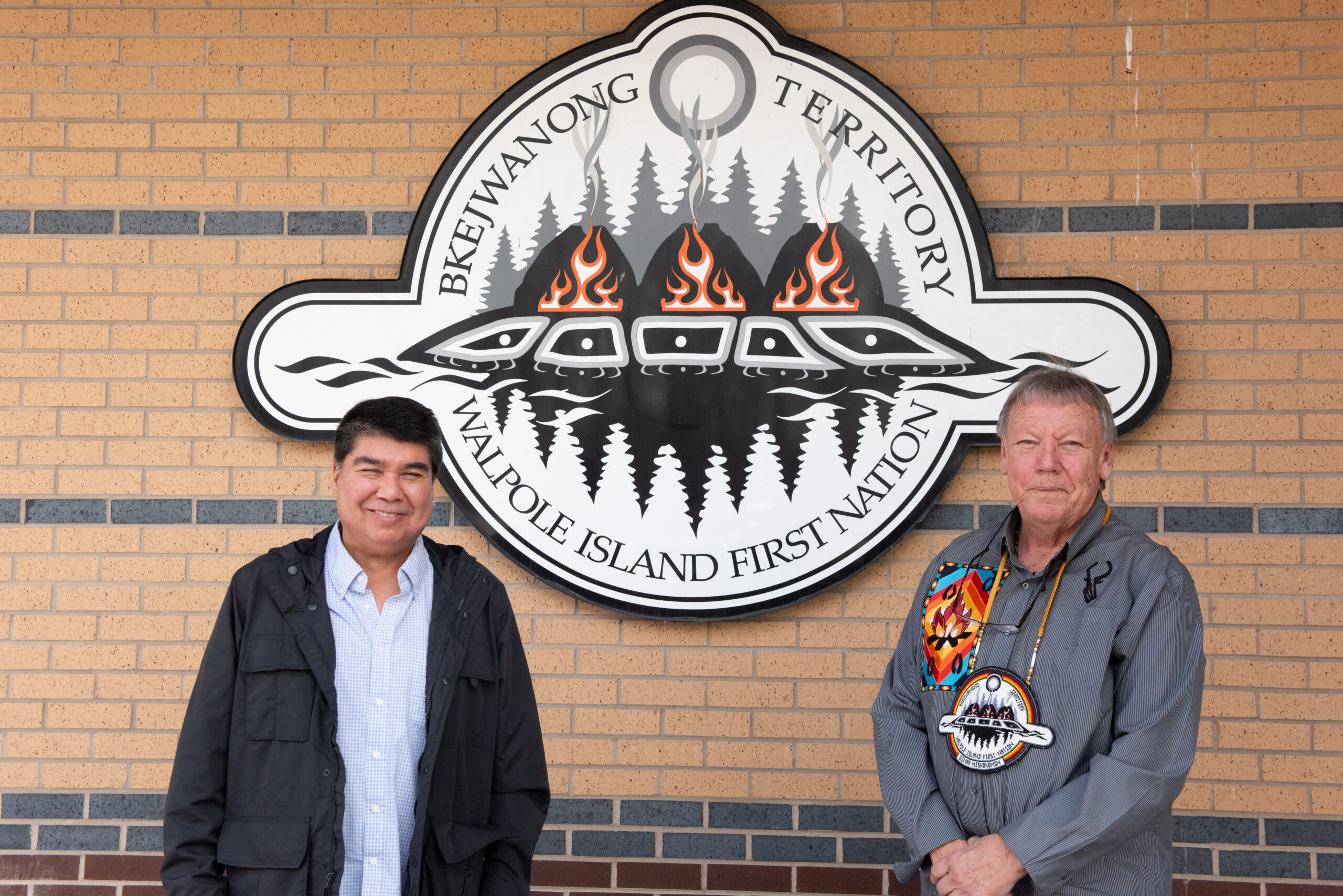 Ojibway National Urban Park: Walpole Island First Nation Chief Dan Miskokomon (right) and Clint Jacobs, the nation's natural heritage coordinator (left) pose for a photo in front of the Walpole Island First Nation sign on a building.