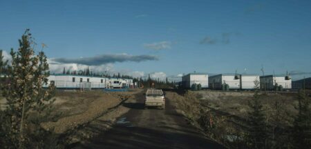 A truck in the middle of the road driving in the opposite direction.
