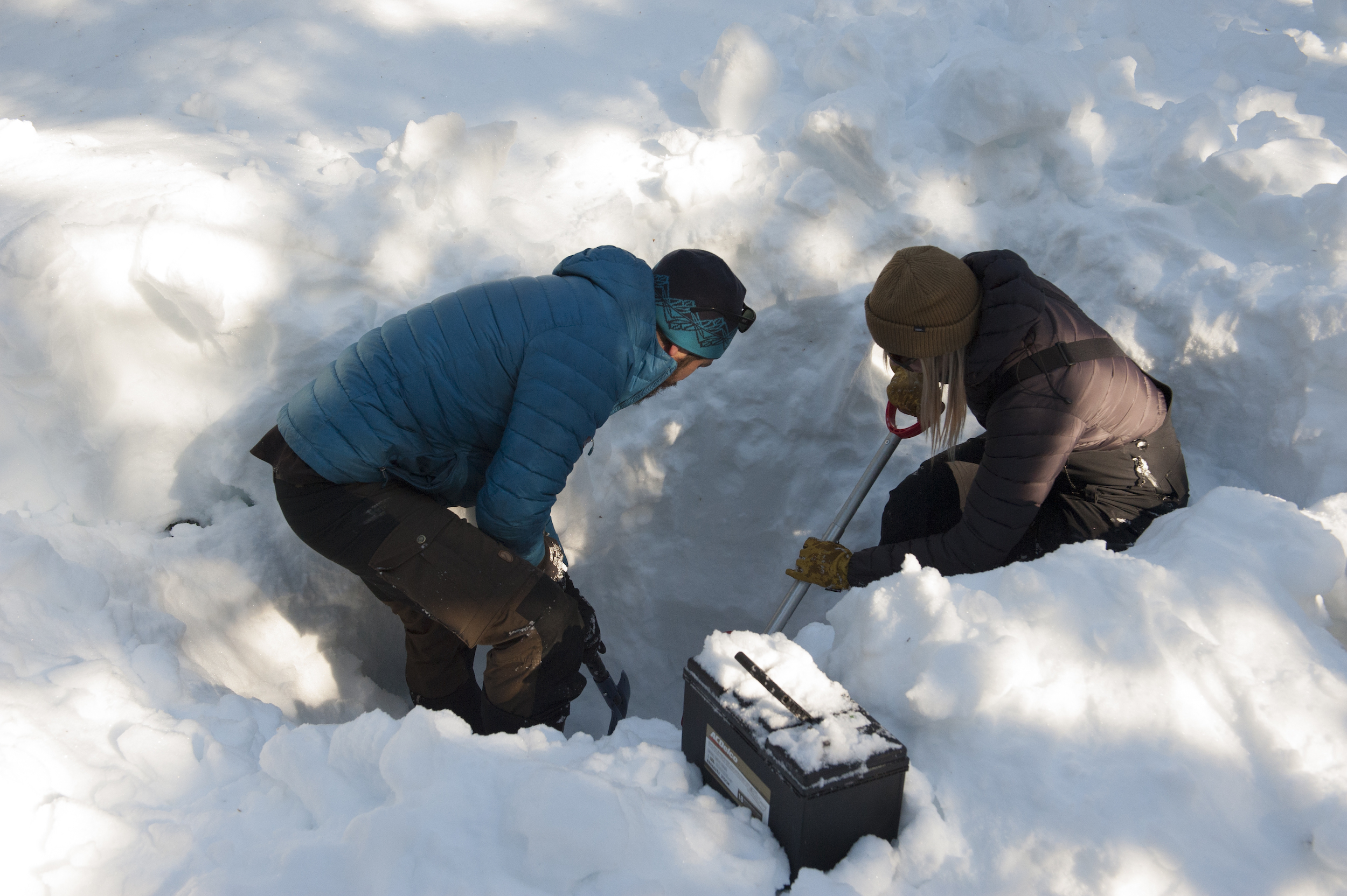 Government researchers digging equipment out of the snow
