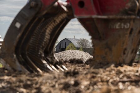 Ontario Greenbelt: a barn is seen through the claws of construction equipment