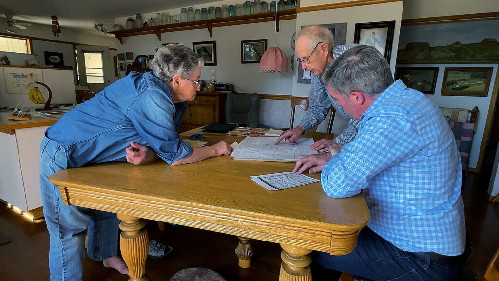 Bill and Sylvia Flesher look at documents related to the orphan well on their Alberta land