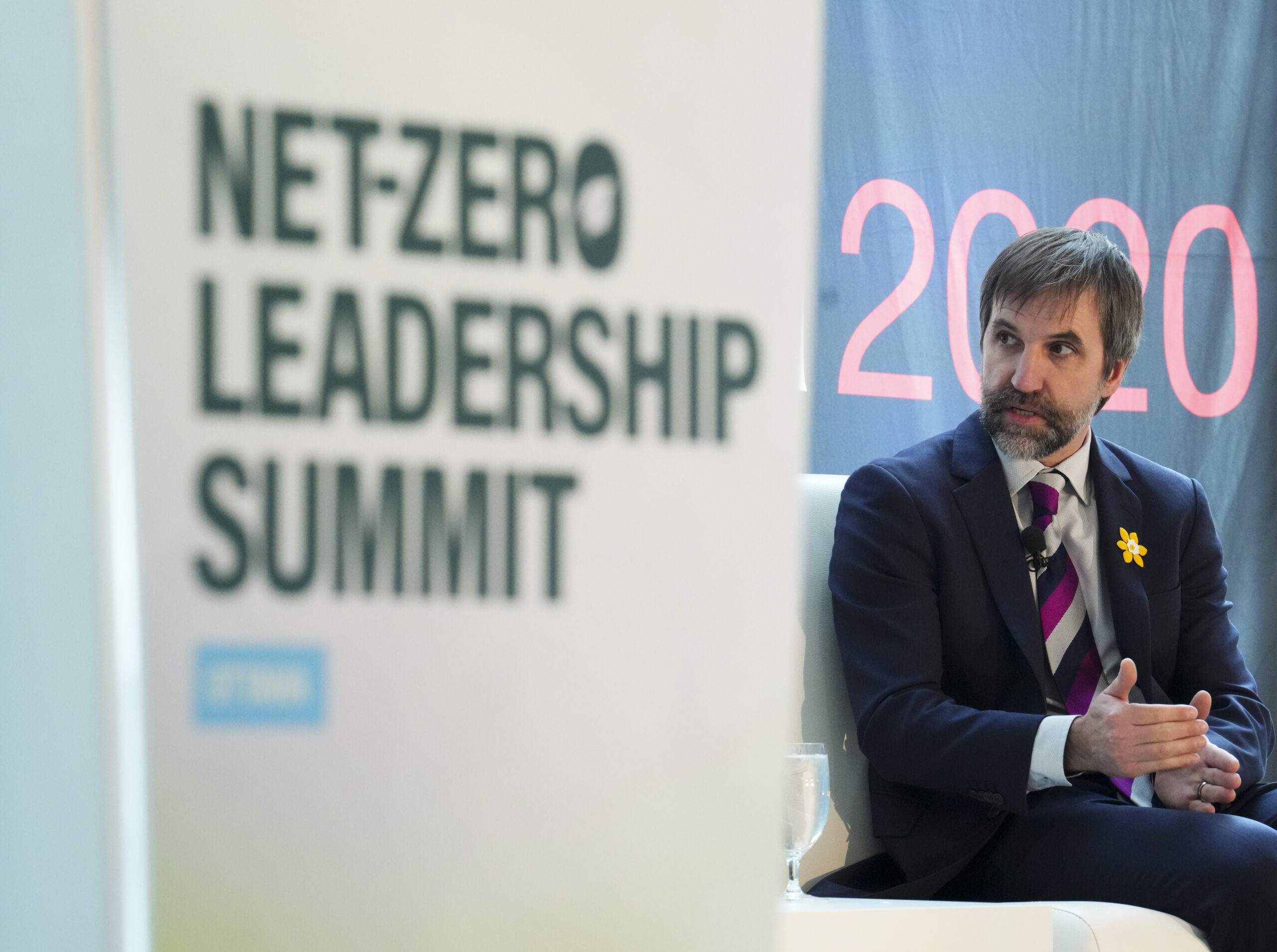 Minister of Environment and Climate Change Steven Guilbeault sits on stage at a net-zero summit