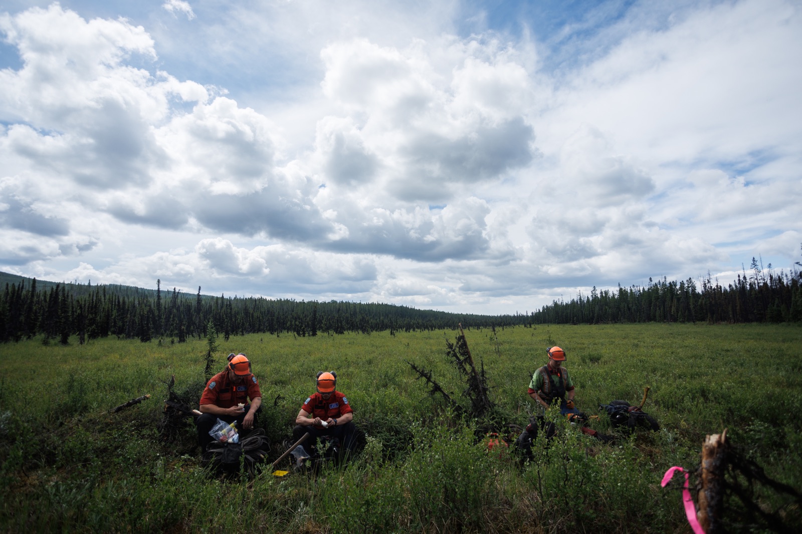 BC Wildfire: a group of firefighters take their lunch break in a swampy field