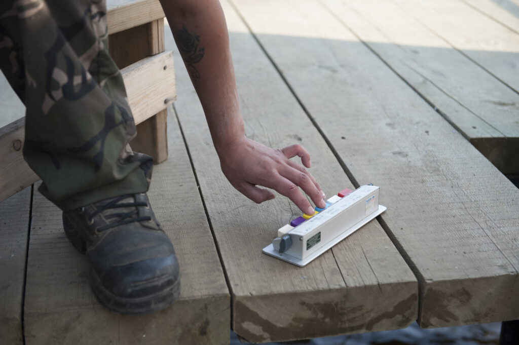 A fisheries worker with Lake Babine Nation counts salmon as they pass