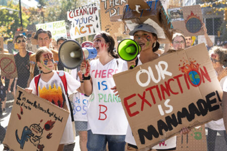 Youth march holding signs and megaphones at the 2023 Vancouver climate strike