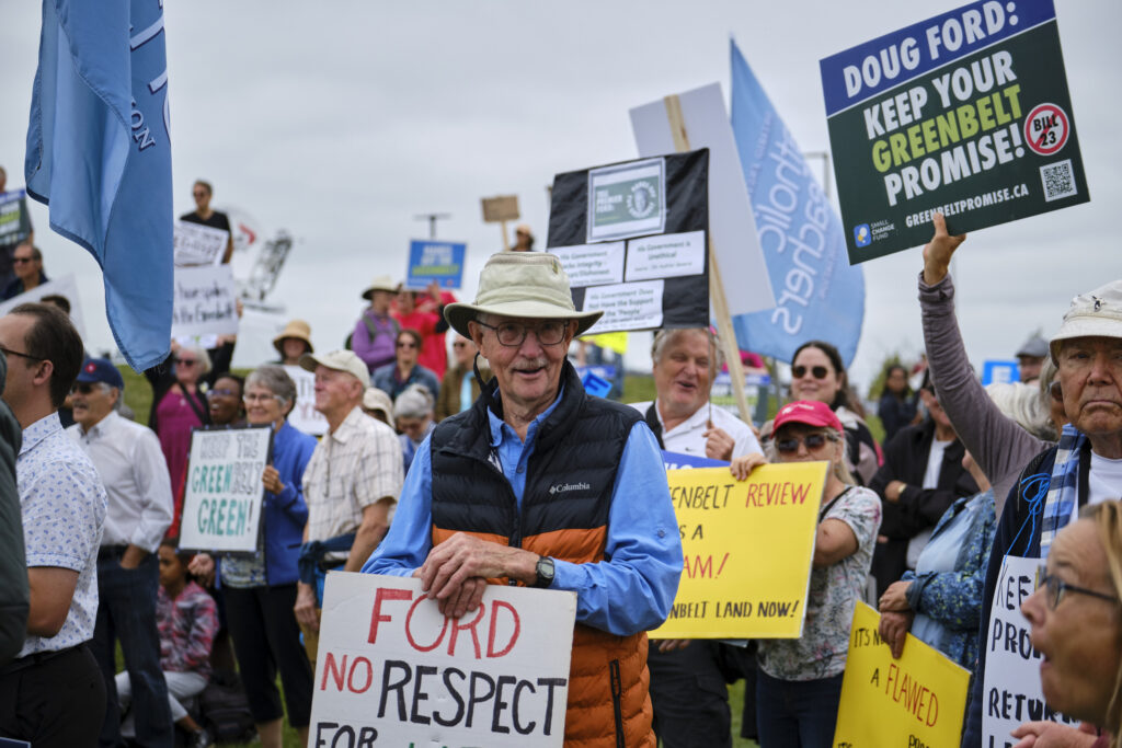 Greenbelt scandal: protestors with signs saying "Doug Ford: keep your Greenbelt promise" and other slogs
