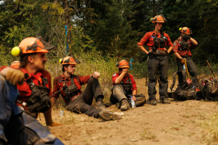 Firefighters from the B.C. Wildfire Service take a break amid 30-degree weather while working on a wildfire near Adams Lake in early August, 2023.