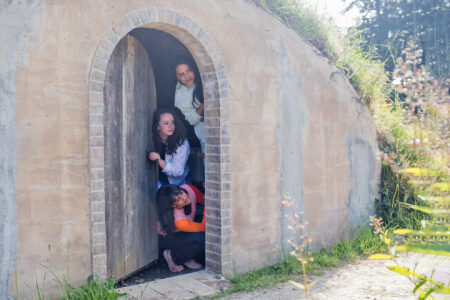 The trio of The Narwhal’s Ontario bureau poke their heads out of a brick hut. From top: Fatima Syed, Emma McIntosh, Denise Balkissoon.