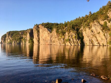 View across the water of cliffs in Bon Echo Park, Ont.