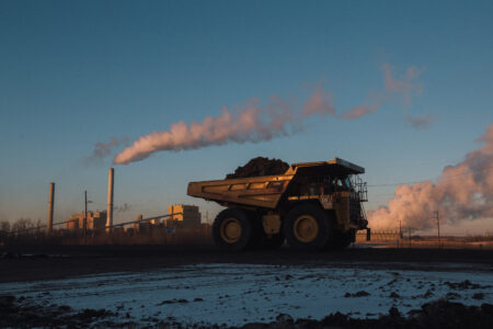 A truck full of coal travels between coal mine sites near Wabamun, Alberta