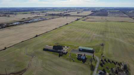Hamilton urban boundary: An aerial view of farmland dotted with trees and a few buildings