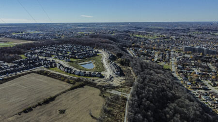 An aerial view of Stoney Creek, Ont., near Hamilton, showing farmland and forest surrounded by housing.