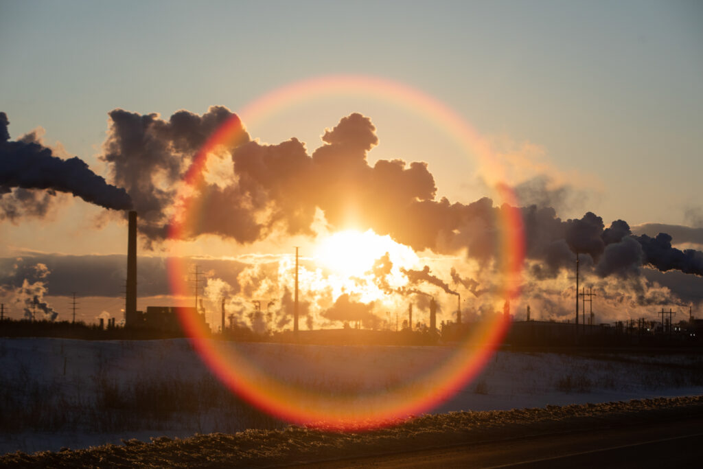 Plumes are silhouetted against the sky at the Syncrude Mildred Lake upgrader in the Alberta oilsands