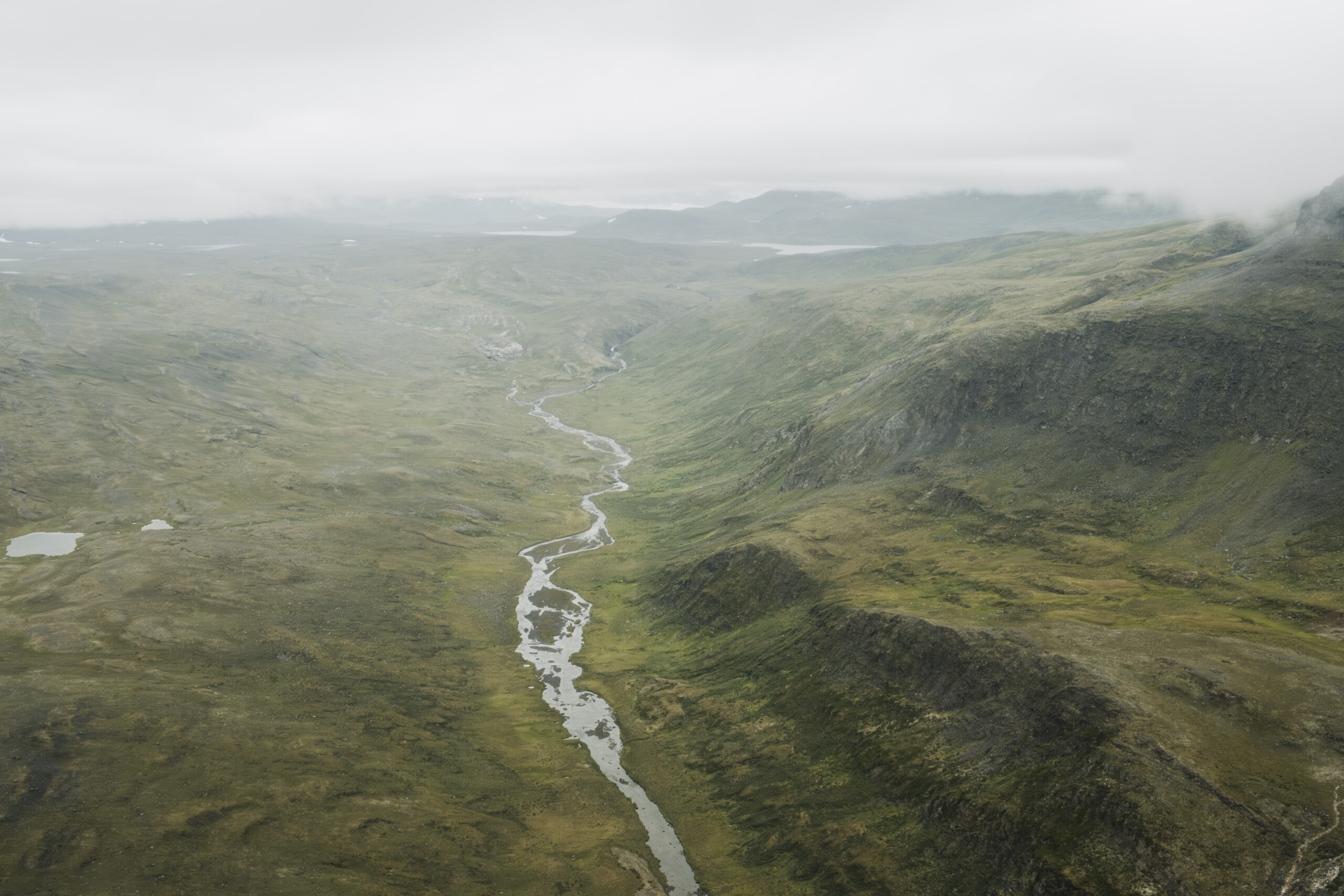 Torngat Mountains National Park: A Creek runs through a green valley in the Torngat Mountains.