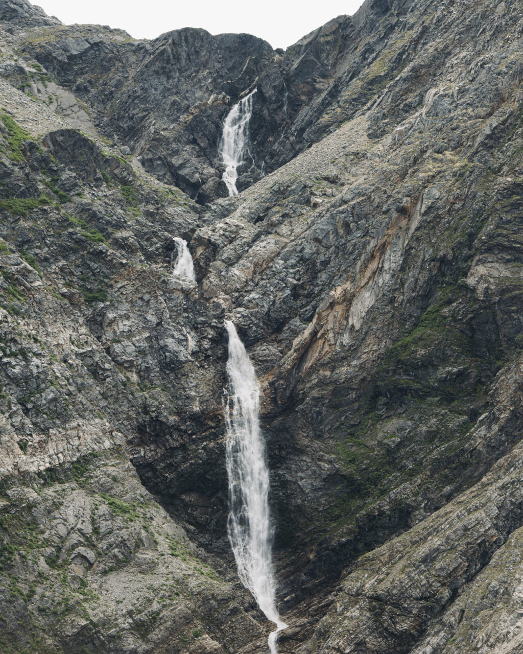 A waterfull pours down a rockface in the Torngat Mountains
