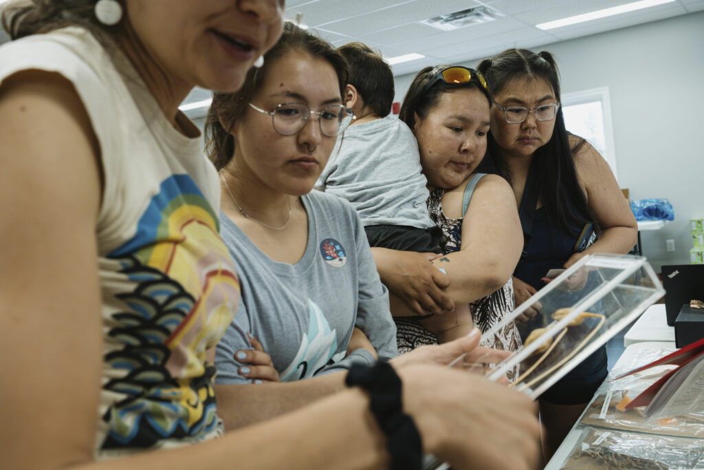 Barbara Neves, a research scientist with the Department of Fisheries and Oceans, shows coral samples to Nain residents at a science fair in the community.
