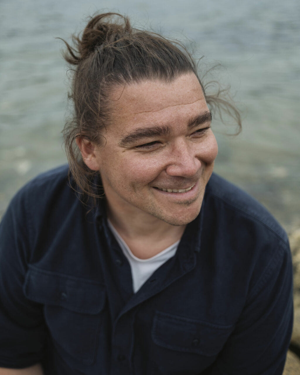 Rodd Laing, Director of Environment for the Nunatsiavut Government, sits at the shoreline in Nain, Labrador.