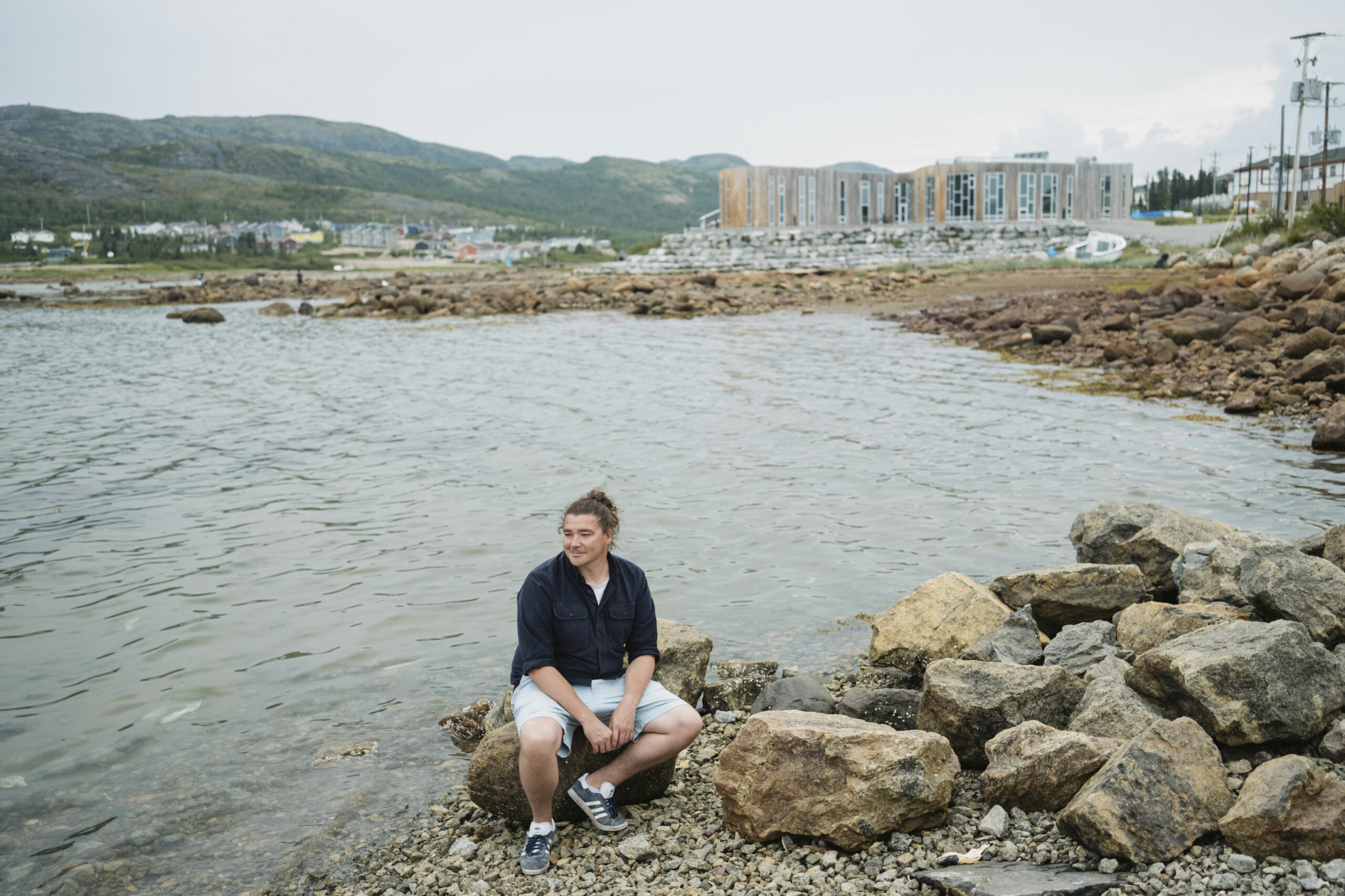 Rodd Laing, Director of Environment for the Nunatsiavut Government, sits at the shoreline in Nain, Labrador.