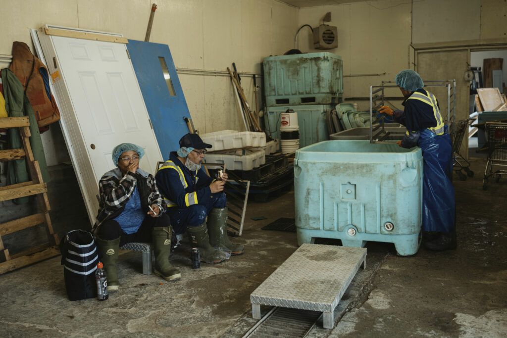 Employees of the fish plant take a break next to the facility in Nain, Labrador.