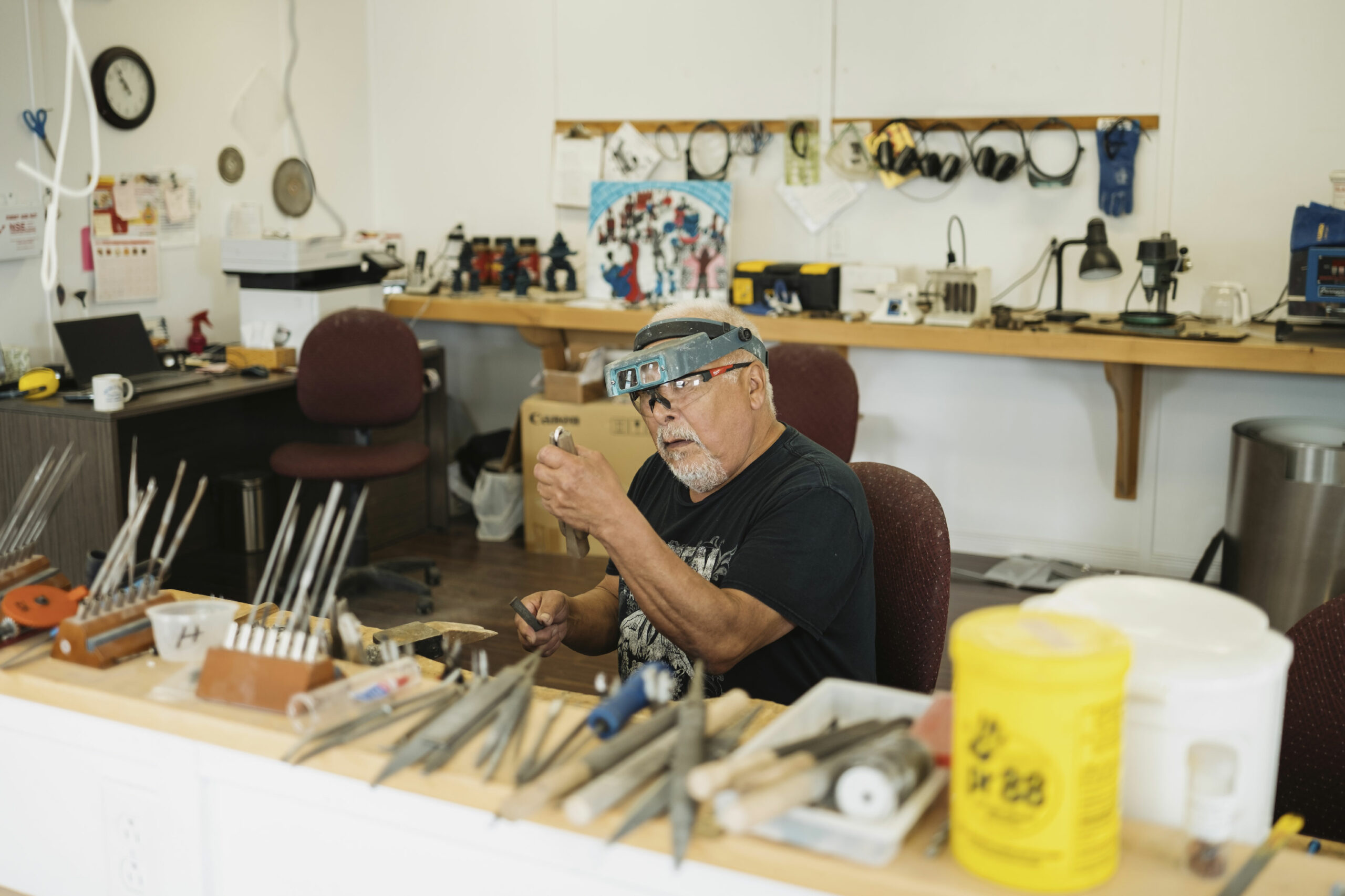 Lukas John Terriaka, a carver and jewelry maker, works on a ring at the carving studio in Nain, Labrador.