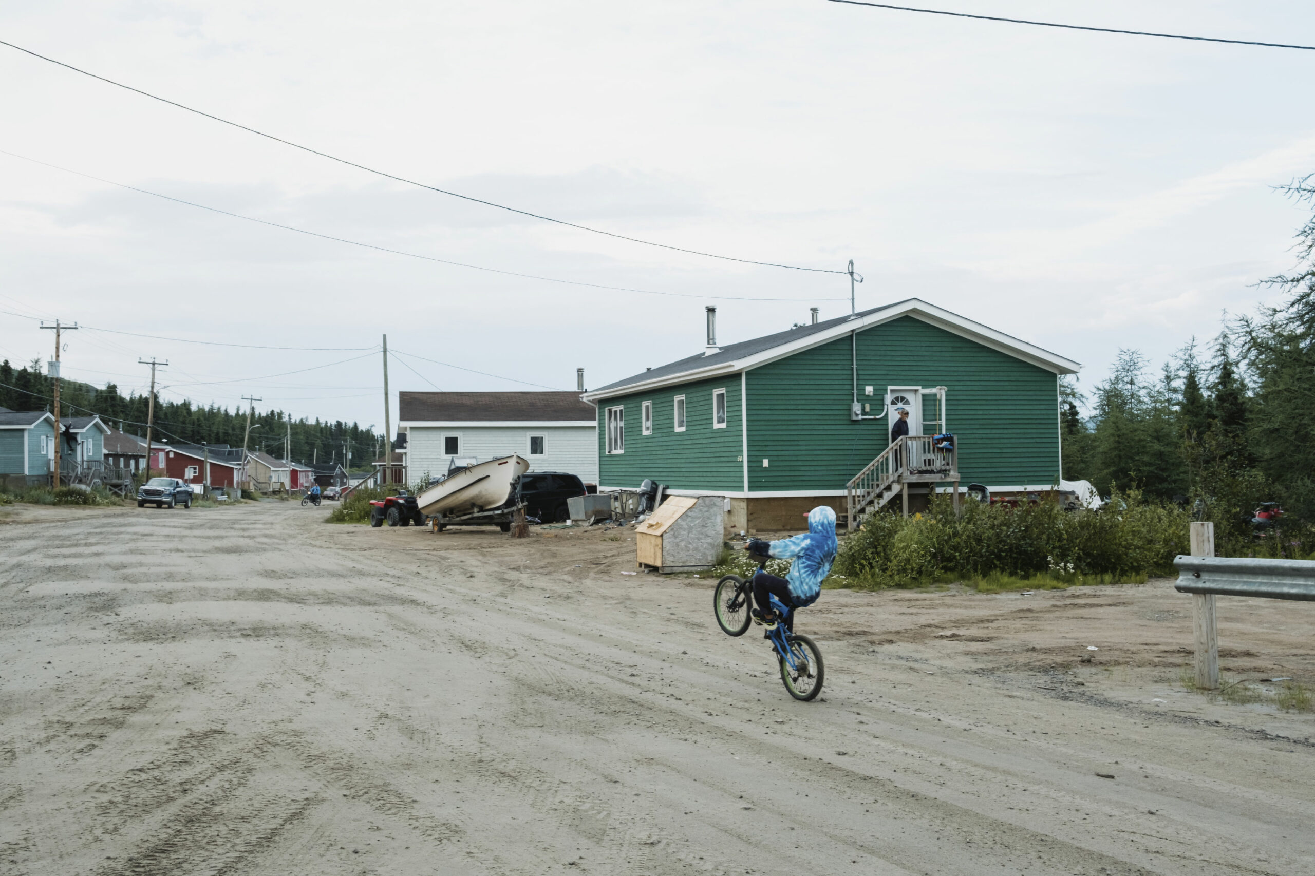 A boy rides his bike through the streets of Nain, Labrador.