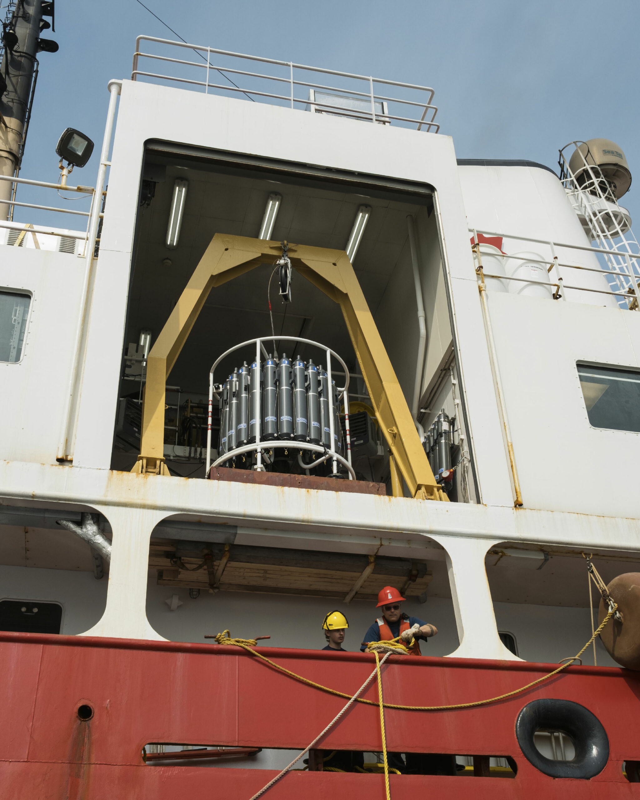 Deckhands bring a barge of visitors to the Amundsen, a research vessel and icebreaker of the Canadian government, in Nain, Labrador.