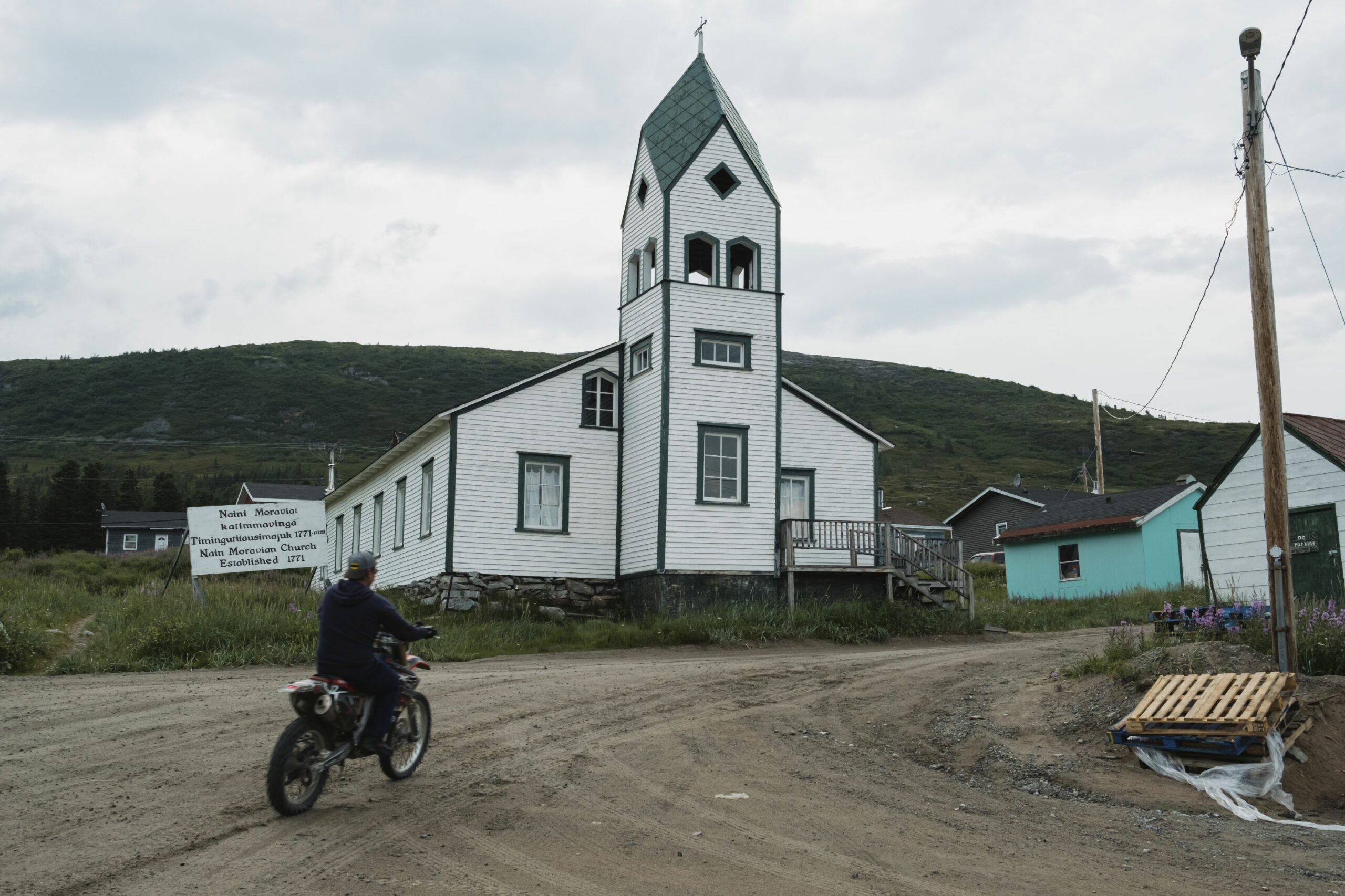 A motorbike passes the Moravian Church in Nain, Labrador.