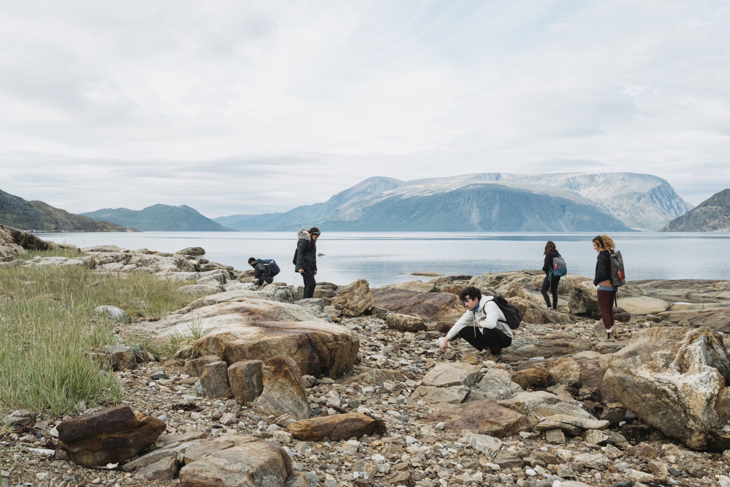 Visitors and students from a youth leadership program explore Rose Island, a sacred place in Torngat Mountains National Park, with important burial grounds and archeological sites including a former sod home.