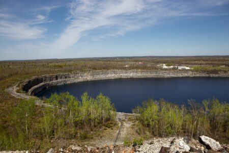 A large pit filled with water, surrounded by forest in Marmora, Ont.
