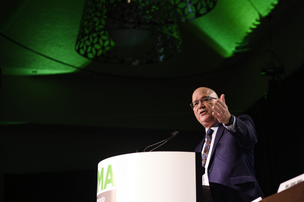 Ontario Greenbelt: Steve Clark speaks at a lecturn, gesturing with one hand