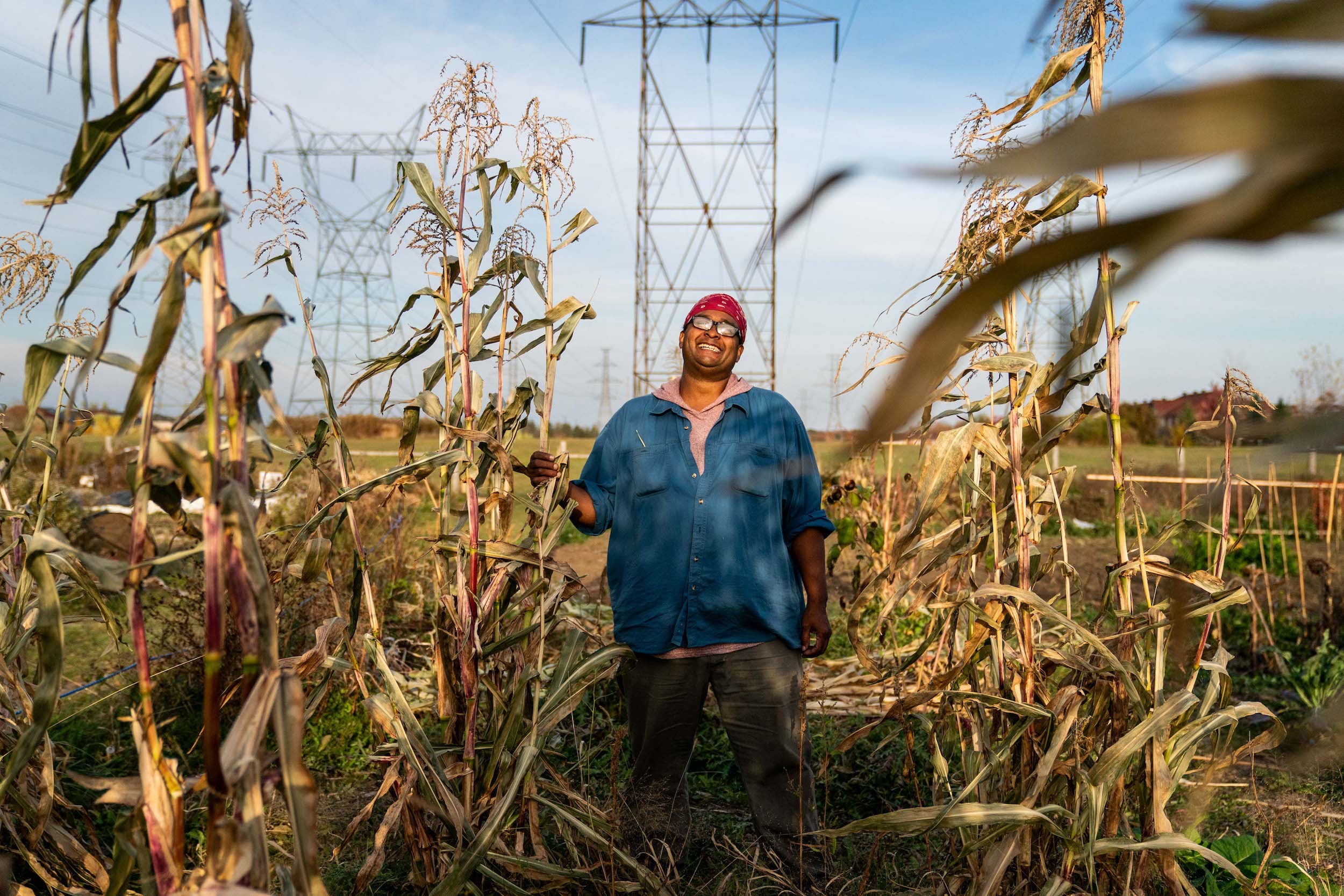 Afro-Indigenous farmer Isaac Crosby stands in between his three sisters plants at Crosby Gitigaan at Malvern Urban Farm in Scarborough, Toronto.