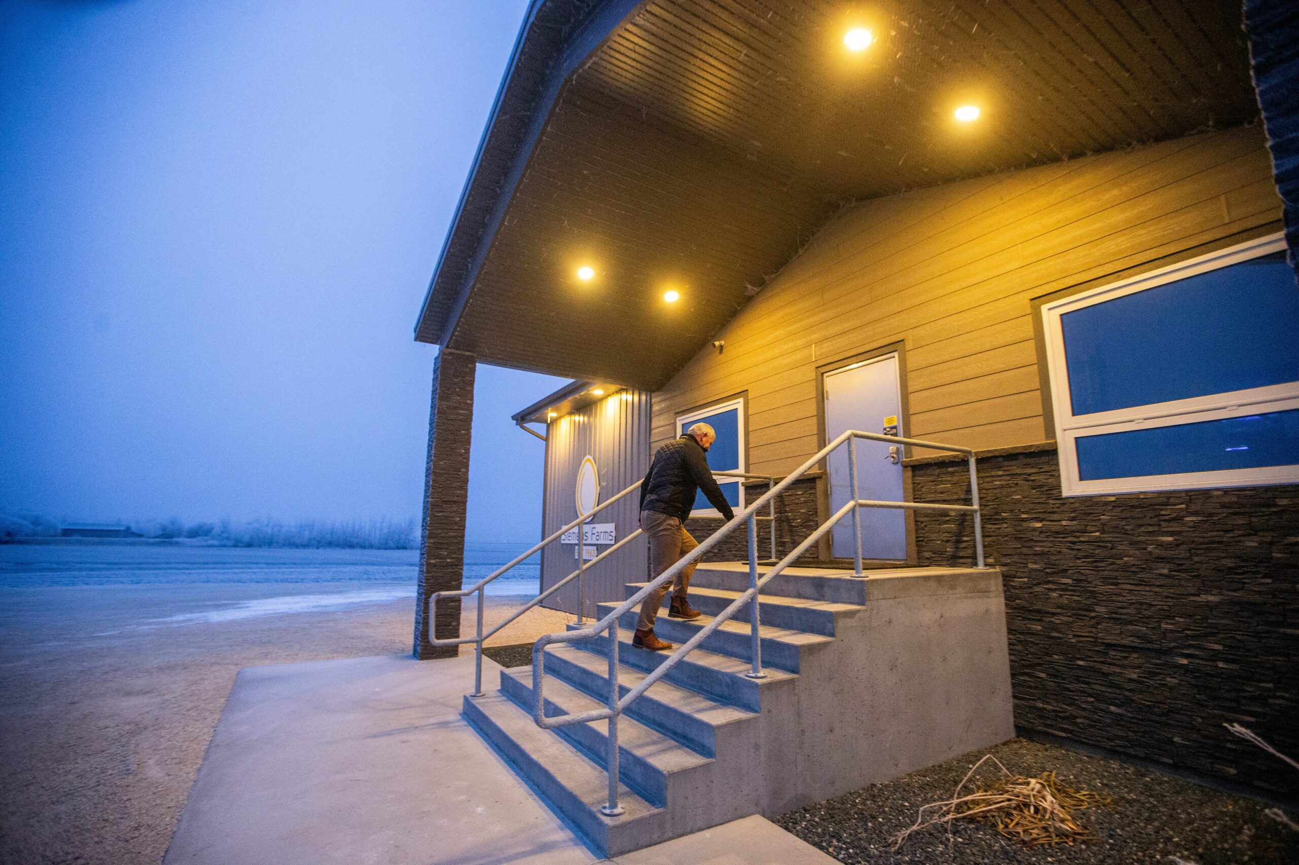 Kurt Siemens climbs concrete stairs of his Rosenort, Manitoba egg farm