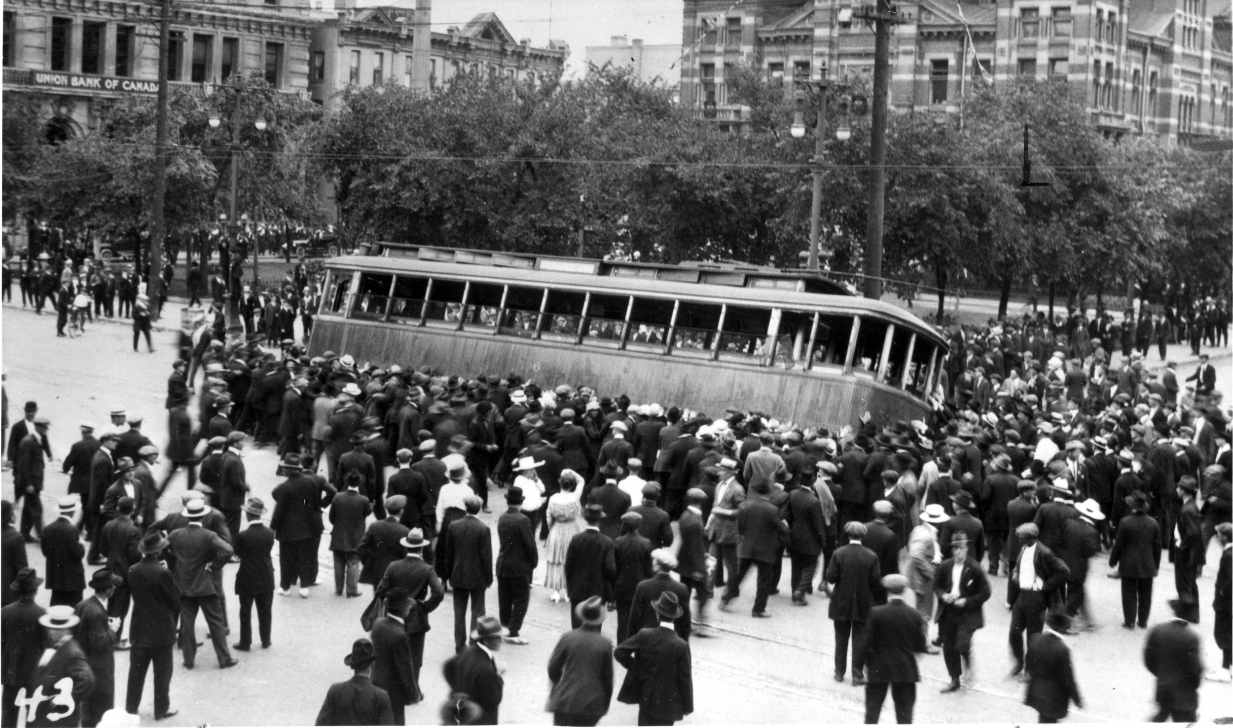 A crowd tips a Winnipeg streetcar during the 1919 General Strike