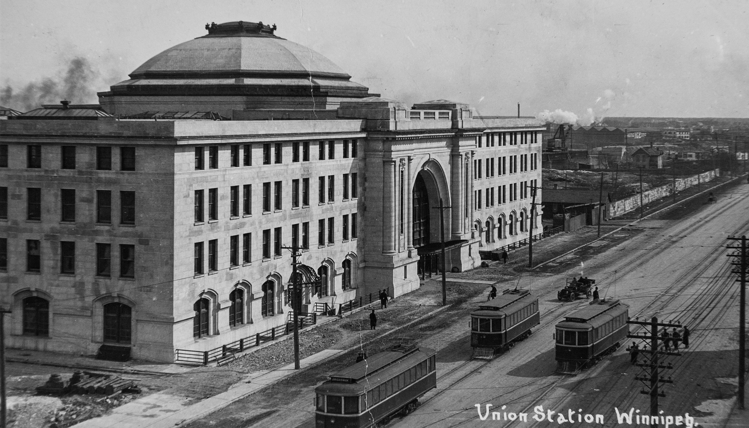 The national railway station, Union Station, in Winnipeg with three streetcars on tracks out front in 1911