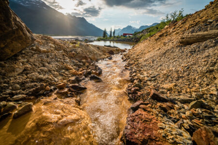 Water contaminated with acid mine drainage flows into a containment pond near the Tulsequah River.