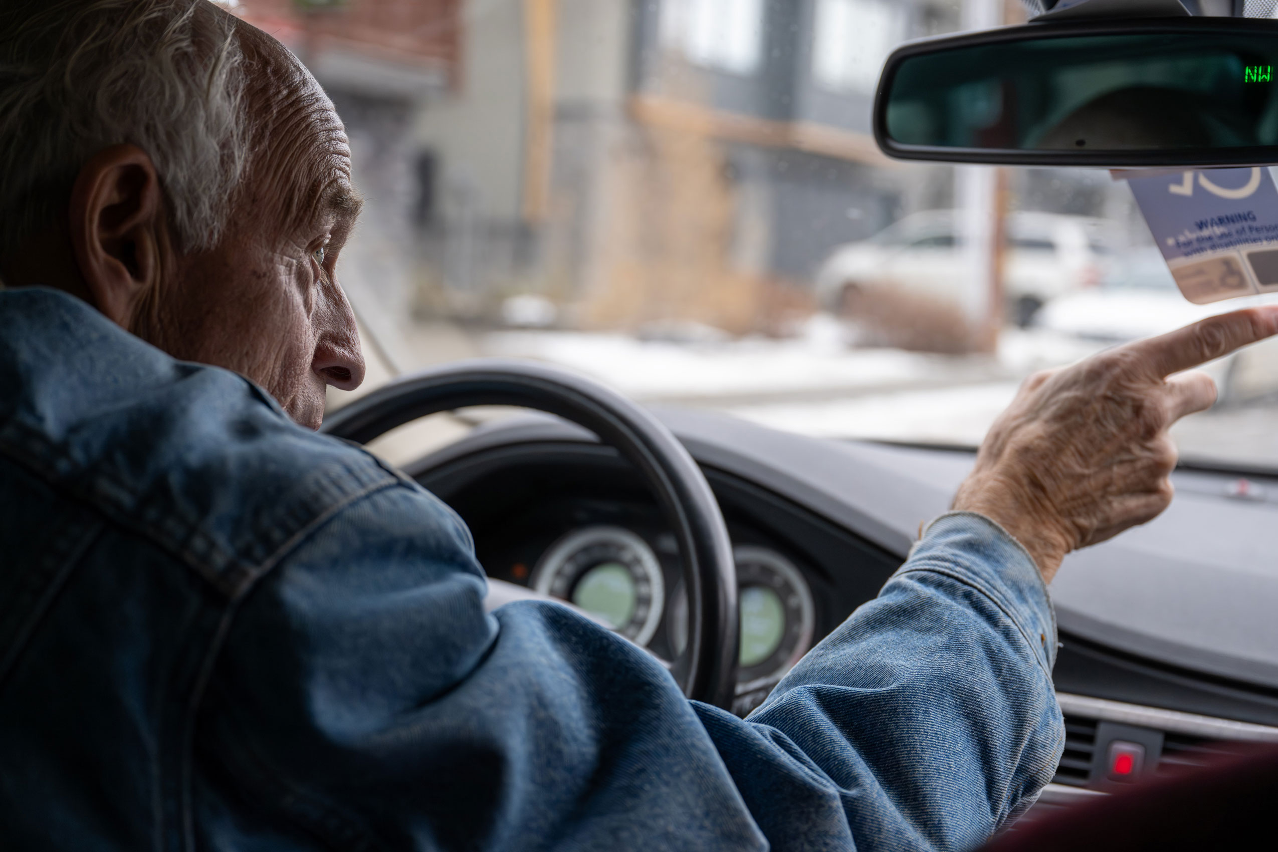 Raymond Haimila points from his car in Canmore, remember it's mining history