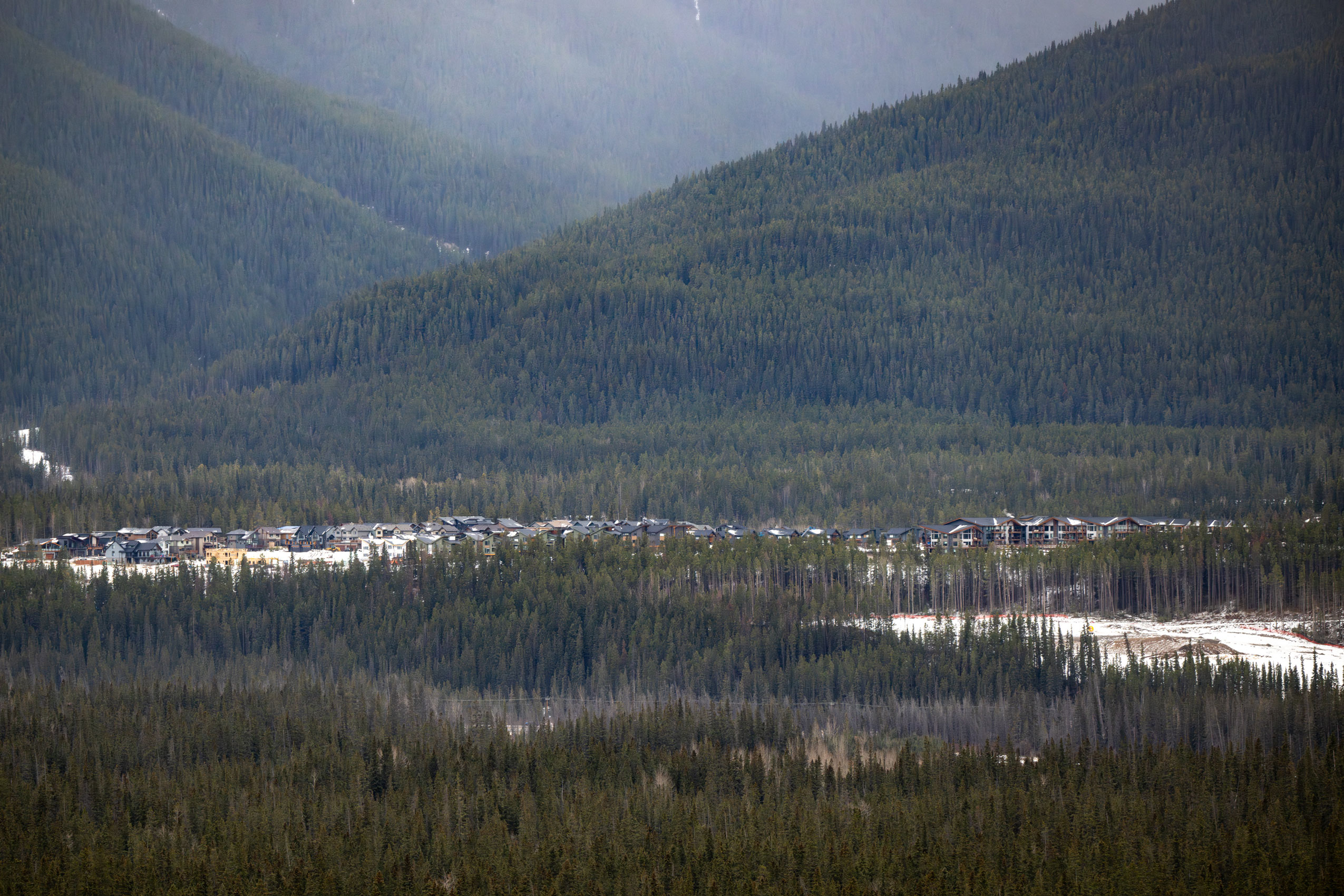 A strip of homes, part of an earlier development, sits on the Three Sisters lands in Canmore