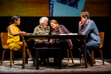 Four people sitting at a table with David Suzuki and Tara Cullis Suzuki at centre, leaning in towards each other