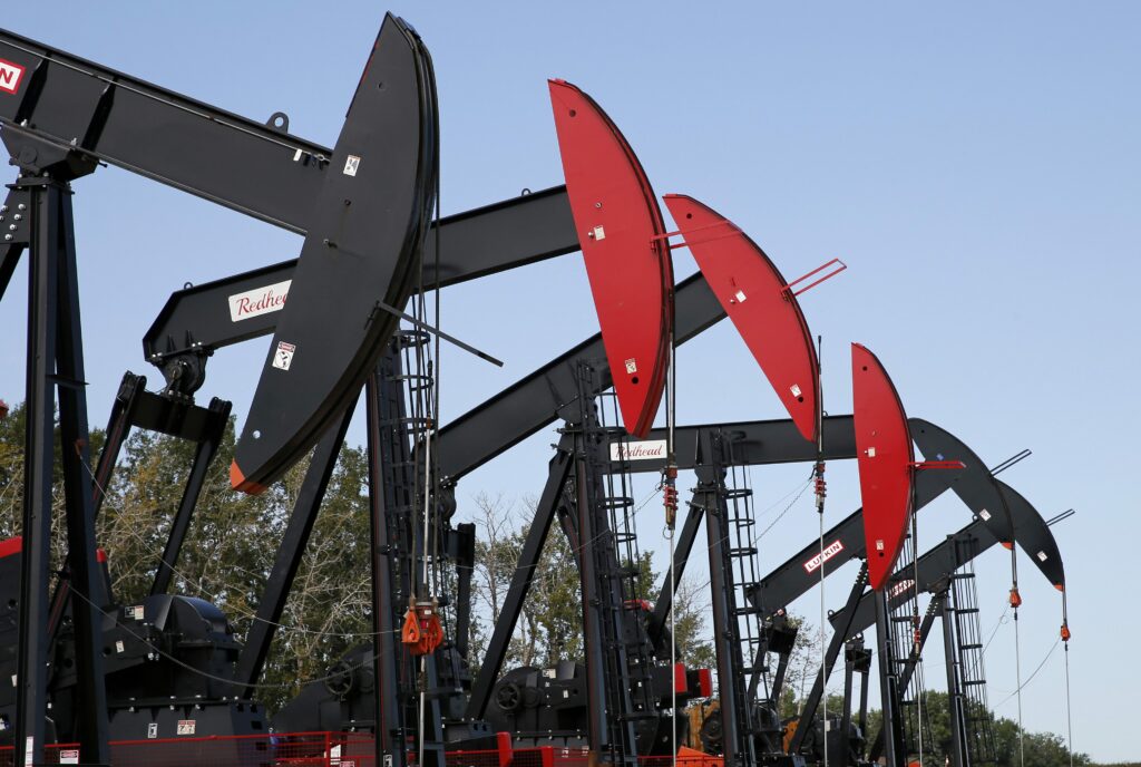 A row of pumpjacks working to bring oil from fracked wells in Alberta.