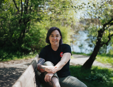 Shannon Waters, The Narwhal's B.C. politics and environment reporter, sits on a bench in Victoria, B.C.