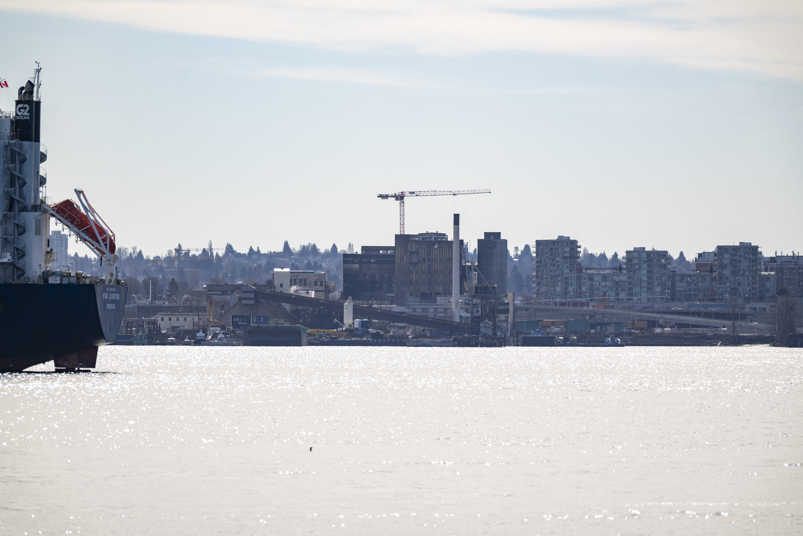 A view from across the inlet of the Rogers Sugar refinery with Vancouver visible in the background
