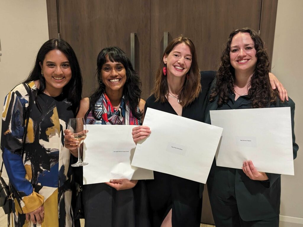Fatima Syed, Denise Balkissoon, Michelle Cyca and Emma McIntosh pose for a group shot, holding award certificate envelopes.