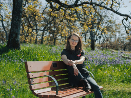 Jacqueline Ronson, The Narwhal's assistant editor, seated on a bench