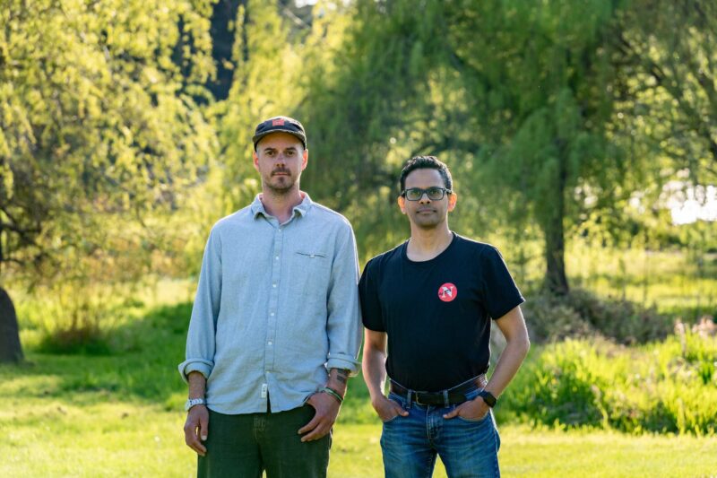 The Narwhal's Matt Simmons and Mike De Souza standing in a field (from left to right).