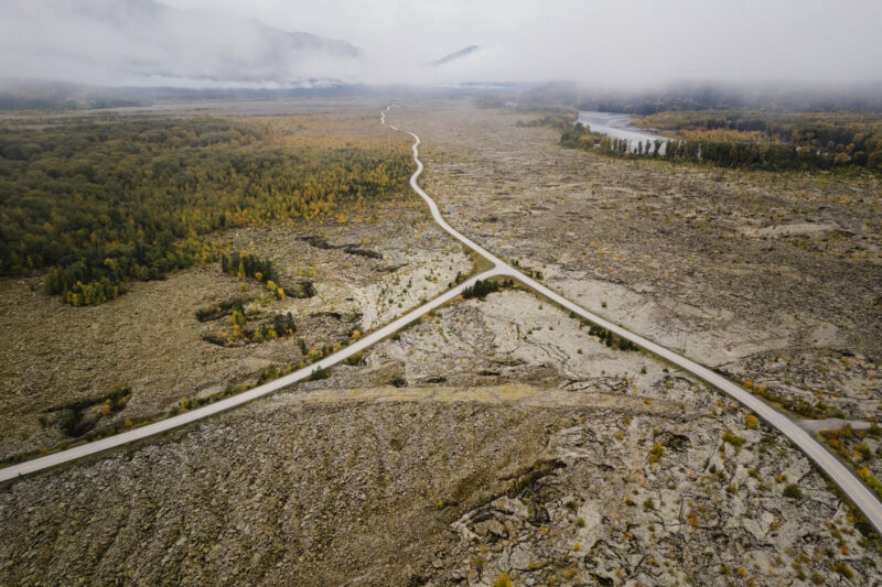 Aerial view of roads cutting through Nisga'a lava beds, with Nass River in the distance