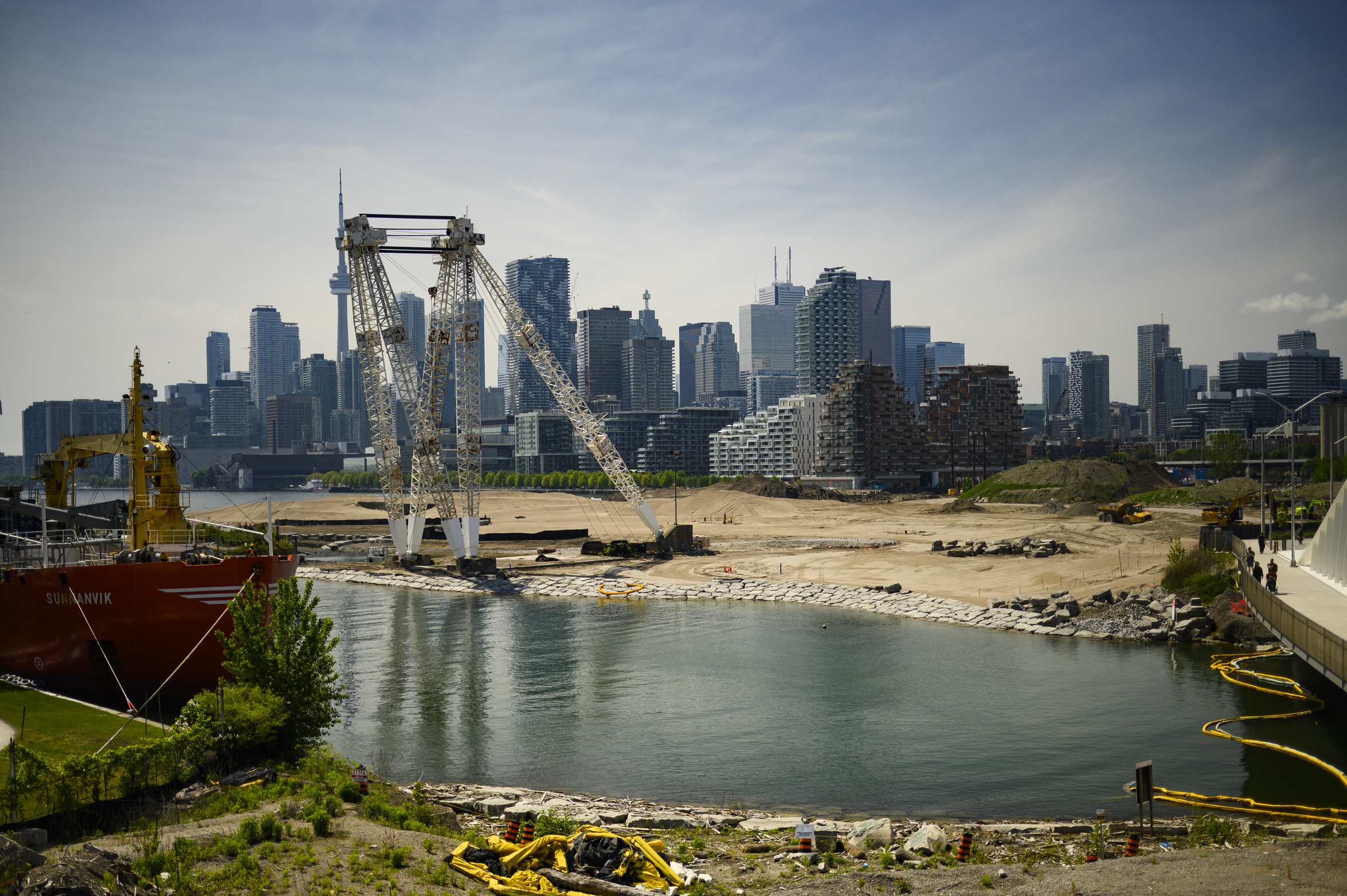 Green* Economy: construction work along the new, re-naturalized mouth of the Don River in Toronto, where water flows beneath a new bridge.