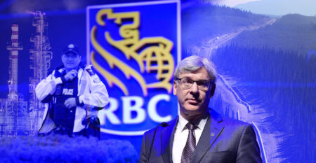 Royal Bank of Canada (RBC) CEO David McKay is seen at the front of a collage that also includes the bank's logo, a police officer at a recent bank, oil and gas infrastructure and a logging road.