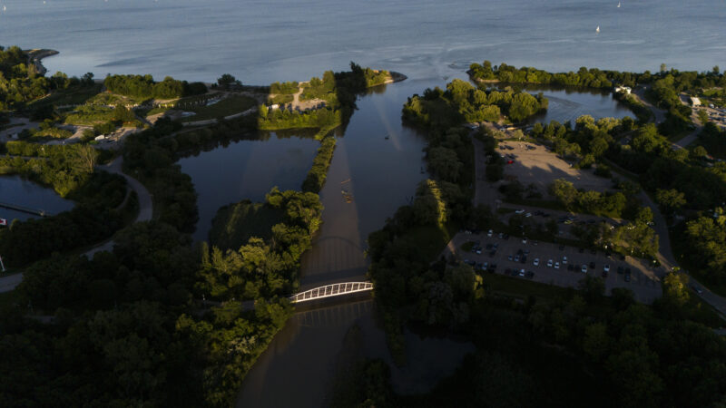 An aerial view of the mouth of Mimico Creek at Humber Bay Park in the summertime, flowing into Lake Ontario